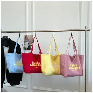 Colorful nylon tote bags hanging on rack, large capacity casual design with letter print.