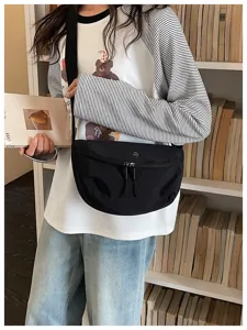 Casual black nylon crescent crossbody bag for women, lightweight daily commuter shoulder bag.