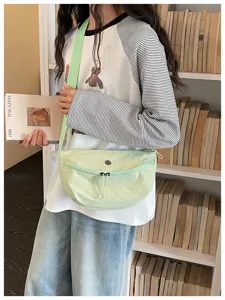 Casual light green crossbody dumpling bag, stylish commuter shoulder bag for women detail view.