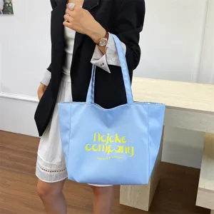 Stylish light blue nylon tote bag, large capacity casual shoulder bag for daily use.