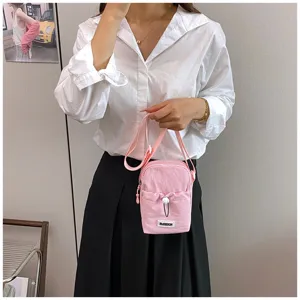 Detailed view of the pink mini crossbody phone bag, showing front pocket and stylish strap.