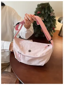 Detail view of pink dumpling crossbody bag, lightweight casual shoulder bag for daily commuting.