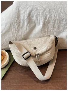Casual solid color nylon dumpling shoulder bag for women, lightweight commuting crossbody bag.