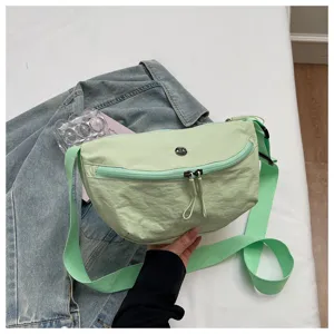 Lightweight solid color nylon crescent bag casual commuter crossbody bag for women daily use.