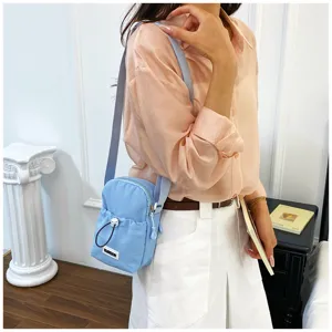 Stylish mini crossbody phone bag for women, cute light blue casual shoulder bag for outdoor use.