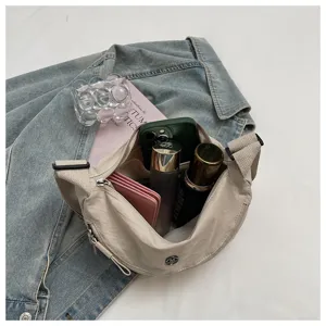 Casual nylon dumpling crossbody bag capacity detail view showcasing spacious interior storage.