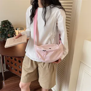 Casual solid color nylon crescent crossbody bag for women, stylish daily commuter sling bag.