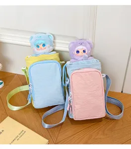 Color-block water bottle crossbody bag with cute plush doll, casual outdoor phone bag.