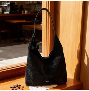 Detail shot of a black vintage suede hobo shoulder bag with large capacity, chic lazy style.