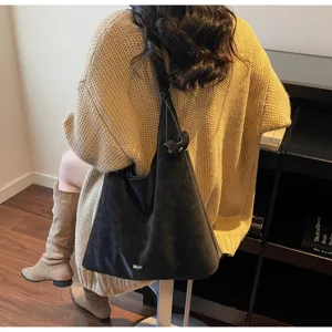 Detailed view of the autumn winter slouchy black shoulder bag, showing the soft suede texture.