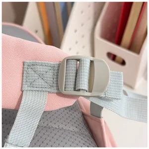 Detailed view of the pink and grey kindergarten backpack shoulder strap, buckle, and mesh.