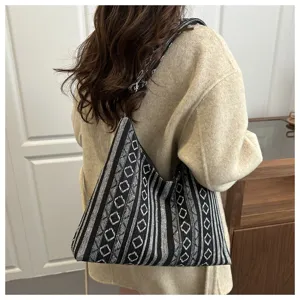 Women ethnic knit shoulder bag detail view, stylish black and white geometric hobo bag.