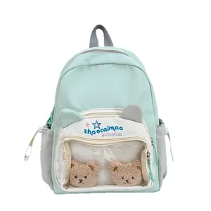 Mochila escolar verde menta con orejas de oso y bolsillo transparente con peluches lindos.