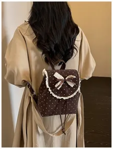 Chic brown polka dot backpack detail featuring lace trim and cute bow. Sweet daily style.