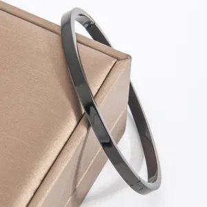 Minimalist black polished stainless steel bracelet detail shot showing sleek surface.
