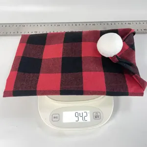 Red and black plaid Christmas chair cover detail shot showing weight on digital scale.