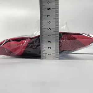Red and black plaid Christmas chair cover detail view showing folded thickness measurement.
