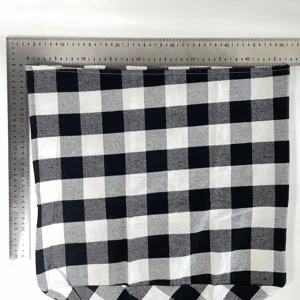 Black and white plaid fabric detail showing dimensions with metal ruler for home decor.