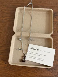 Vintage leopard cat pendant necklace detail showing dainty beaded chain and charms.