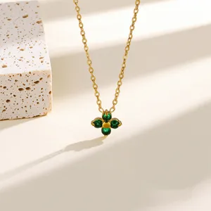 Detailed close-up shot of gold-plated green clover pendant necklace, elegant clavicle jewelry.
