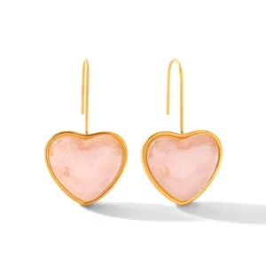 Detail shot of pink resin heart dangle earrings with gold-plated stainless steel hooks.