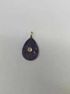 Natural amethyst teardrop pendant with carved sunburst detail and center stone for DIY necklace.