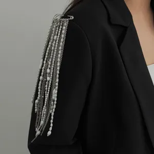 Stylish pearl tassel shoulder brooch pin detail, elegant multi-layer chain clothing accessory.