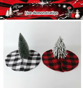Detailed view of plaid Christmas tree skirts with small artificial trees for holiday decor.