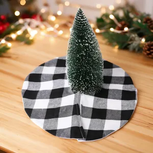 Black and white buffalo plaid Christmas tree skirt with mini table tree for holiday decor.