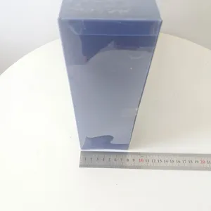 Dark rectangular package displayed on a white table with a measuring ruler for clear detail view.