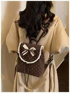 Detailed view of the sweet Korean style polka dot backpack with delicate lace trim and cute bow on back.