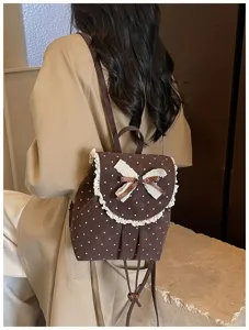 Detailed view of the cute brown polka dot backpack with sweet lace trim and bow accent.