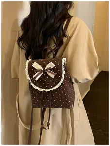 Brown polka dot backpack detail showing sweet lace trim and cute bow decoration design.