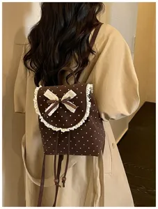 Close-up detail of sweet Korean style brown polka dot backpack featuring delicate lace trim and bow.