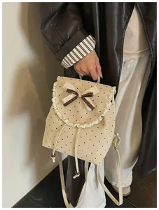 Detailed view of sweet Korean style polka dot backpack with lace trim and bow knot.