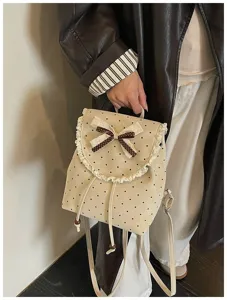 Detailed shot of sweet Korean style polka dot backpack with cute lace trim and brown bow.