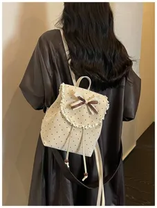 Detail shot of cute sweet style polka dot backpack with delicate lace trim and lovely bow.