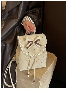 Sweet Korean style polka dot backpack featuring lace trim and cute bow detail. Detail shot.