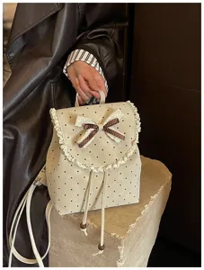 Detailed view of cute Korean style polka dot mini backpack with lace trim and bow.