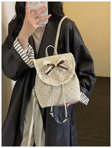 Detailed view of a sweet Korean style polka dot backpack with delicate lace trim and bow.
