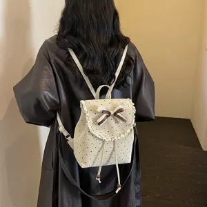 Sweet Japanese style polka dot backpack with cute lace trim and bow design for women daily use.