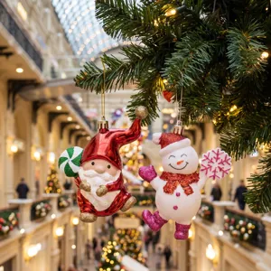 Festive Christmas tree hanging ornaments featuring cute Santa and snowman figures with glitter.