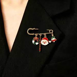 Detailed view of Christmas holiday brooch with Santa Claus, tree, and wreath charms.