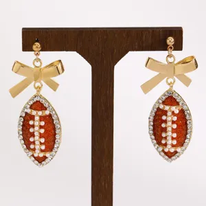 Chic football bow earrings with rhinestones and faux pearls for sports fans and events.