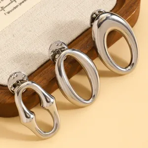 Close-up detail of three silver metal irregular organic shape pins and glasses holders.