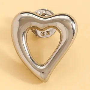 Silver metallic hollow heart brooch pin stylish lapel accessory for women and girls daily wear.