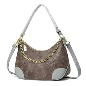 Detailed view of fashionable brown crocodile pattern hobo shoulder bag with chic gold chain.