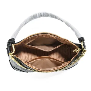Detailed view of the black stylish shoulder bag interior, showing compartments and golden chain.