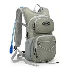 Detailed view of the gray hydration backpack showing mesh straps and blue water tube.