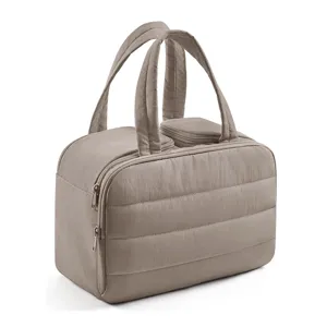 Close-up detail of quilted travel cosmetic bag with double handles and smooth zipper closure.